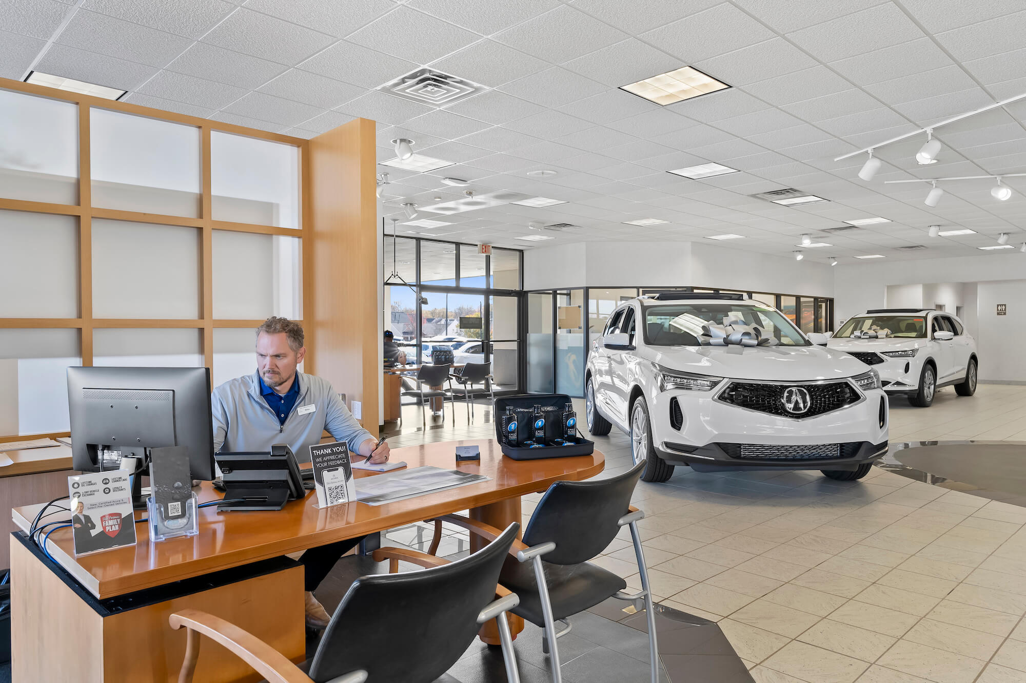Fred Anderson Acura Showroom with Salesman and Vehicles
